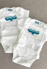 cartagena baby onesie — whale tail linoprint