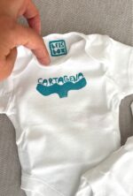 cartagena baby onesie — whale tail linoprint
