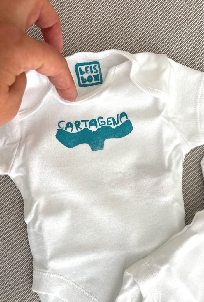 cartagena baby onesie — whale tail linoprint