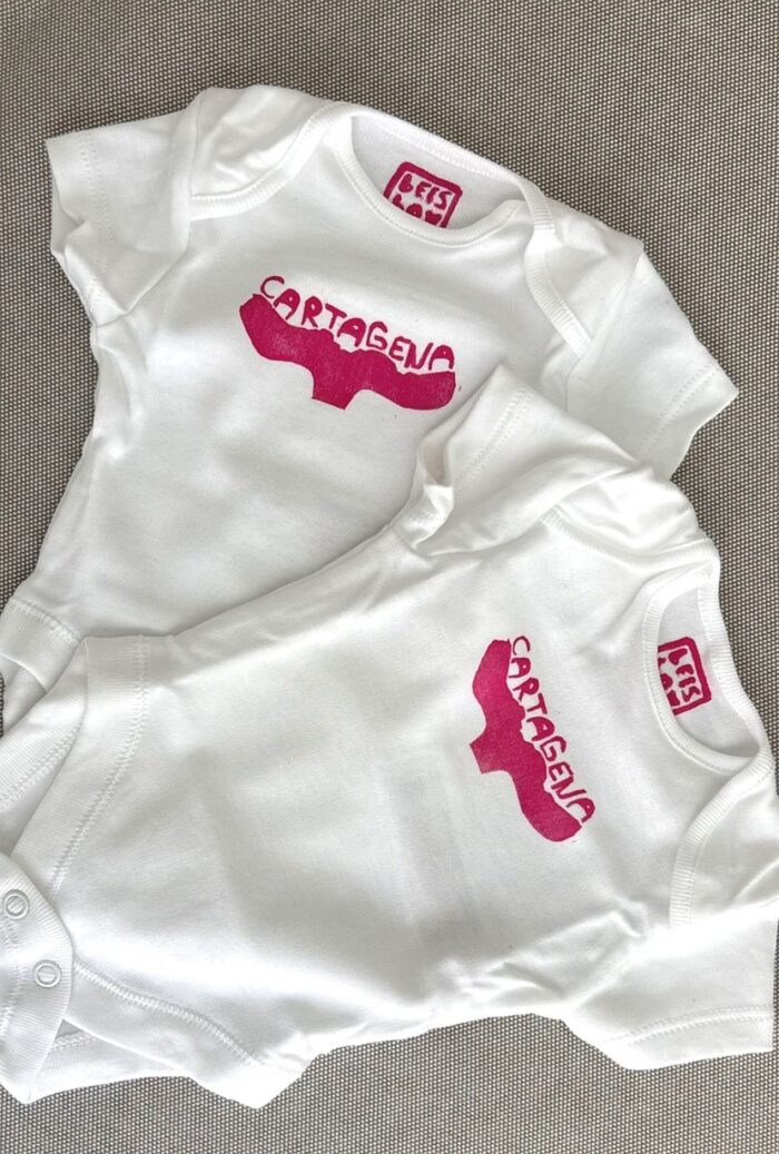 cartagena baby onesie — whale tail linoprint